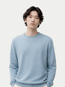 A model light blue crewneck cashmere sweater by COBI, displayed flat against a light gray background. #color_cloud-blue #ai-image