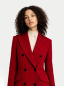 Woman wearing A red, double-breasted, peak lapel long cashmere coat with a V-neck collar and button details a white background . #color_bordeaux  #ai-image