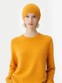 99 Cashmere Hat & Sweater Set Daffodil worn by model, detail view on white background #color_amber-yellow #ai-image