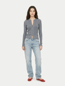 Woman wearing a grey cardigan and light blue jeans on a white background #color_steel-gray 