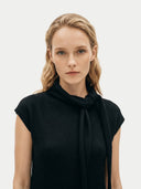 Women's Black Cashmere Tie-Neck Dress worn by model, detail view on white background #color_black