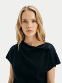 Women's Black Cashmere Asymmetrical Top worn by model, detail view on white background #color_black