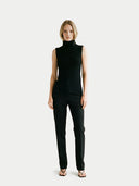 Woman wearing a black sleeveless top and pants on a white background #color_black #ai-image