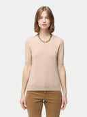 Women's Organic C-Neck Cashmere Top Beige worn by model, detail view on white backround #color_beige
