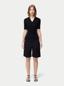 Cashmere Silk Women's Polo Shirt Black worn by model, front view on white background #color_graphite-black