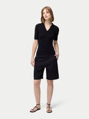 Cashmere Silk Women's Polo Shirt Black worn by model, front view on white background #color_graphite-black
