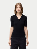 Cashmere Silk Women's Polo Shirt Black worn by model, detail view on white background #color_graphite-black
