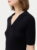 Cashmere Silk Women's Polo Shirt Black worn by model, detail view on white background #color_graphite-black