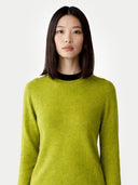 Women's Spinach Green Cashmere Crewneck Sweater worn by model, detail view on white background #color_lime-green #ai-image