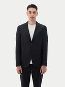Men's Black single-breasted cashmere blazer worn by model, detail view on white background #color_black