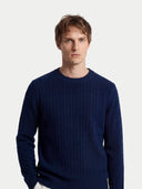 Men's Navy Cashmere Cable-Knit Sweater worn by model, detail view on white background #color_navy-blue