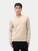 Men's Beige Cashmere Crewneck Sweater woen by model detail view on white background #color_beige