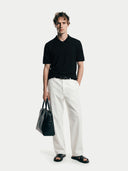 Men's Black Cashmere Silk Half-Zip Polo Top worn by model, front view on white background #color_graphite-black #ai-image