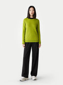 Women's Spinach Green Cashmere Crewneck Sweater worn by model, front view on white background #color_lime-green #ai-image