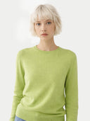 Person wearing a light green sweater on a white background. #color_jade-green #ai-image
