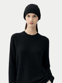 Woman wearing a black headscarf and black jumper on a white background #color_black #ai-image