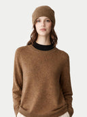 Woman wearing a brown jumper and matching beanie on a white background #color_khaki-brown #ai-image