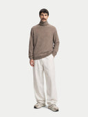 Men's Taupe Turtleneck Cashmere Sweater worn by model, detail view on white background #color_taupe #ai-image