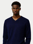 Men's Navy Cashmere V-Neck Sweater worn by model, detail view on white background #color_navy-blue #ai-image