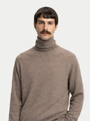 Men's Taupe Turtleneck Cashmere Sweater worn by model, detail view on white background #color_taupe #ai-image