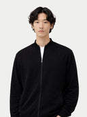 Men's Black Full-Zip Cashmere Cardigan worn by model, detail view on white background #color_black #ai-image