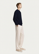 Men's Navy Cashmere Crewneck Sweater worn by model, side view on white background #color_navy #ai-image