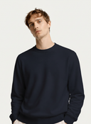 Men's Navy Cashmere Crewneck Sweater worn by model, detail view on white background #color_navy #ai-image