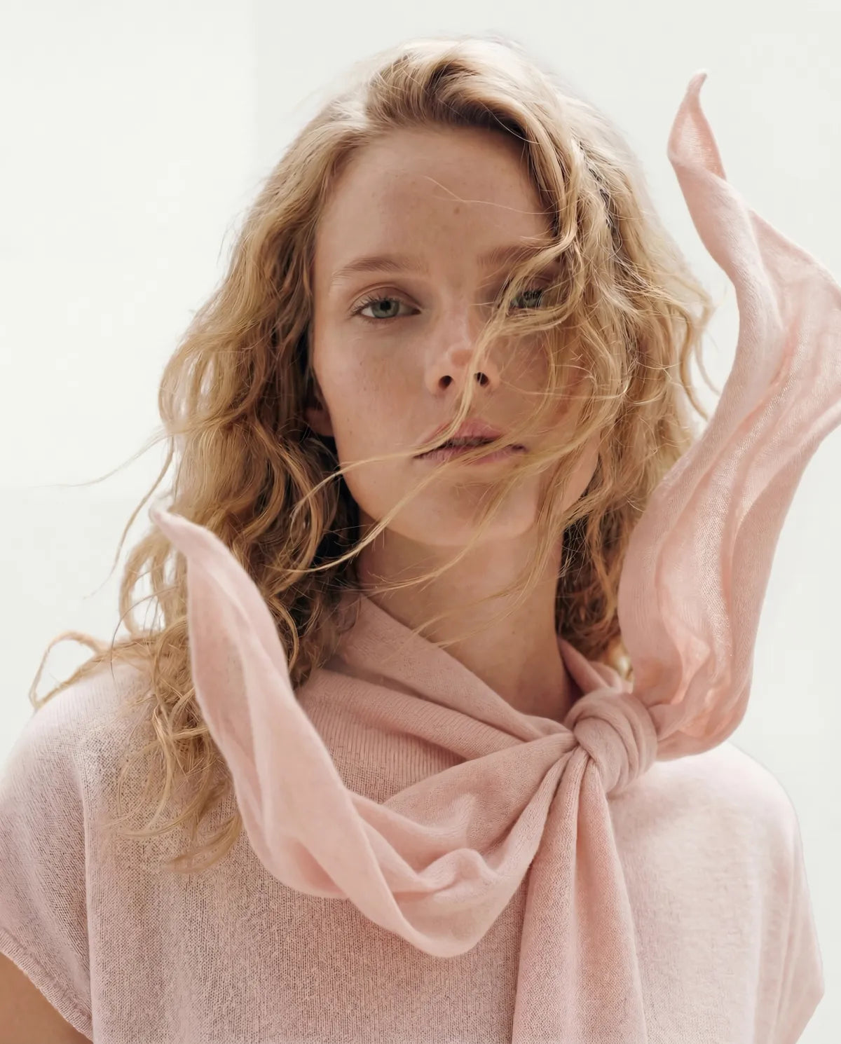 woman wearing baby pink cashmere top with moving neck scarf | GOBI Cashmere